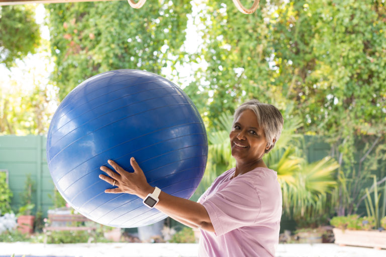 woman with rehab exersize ball
