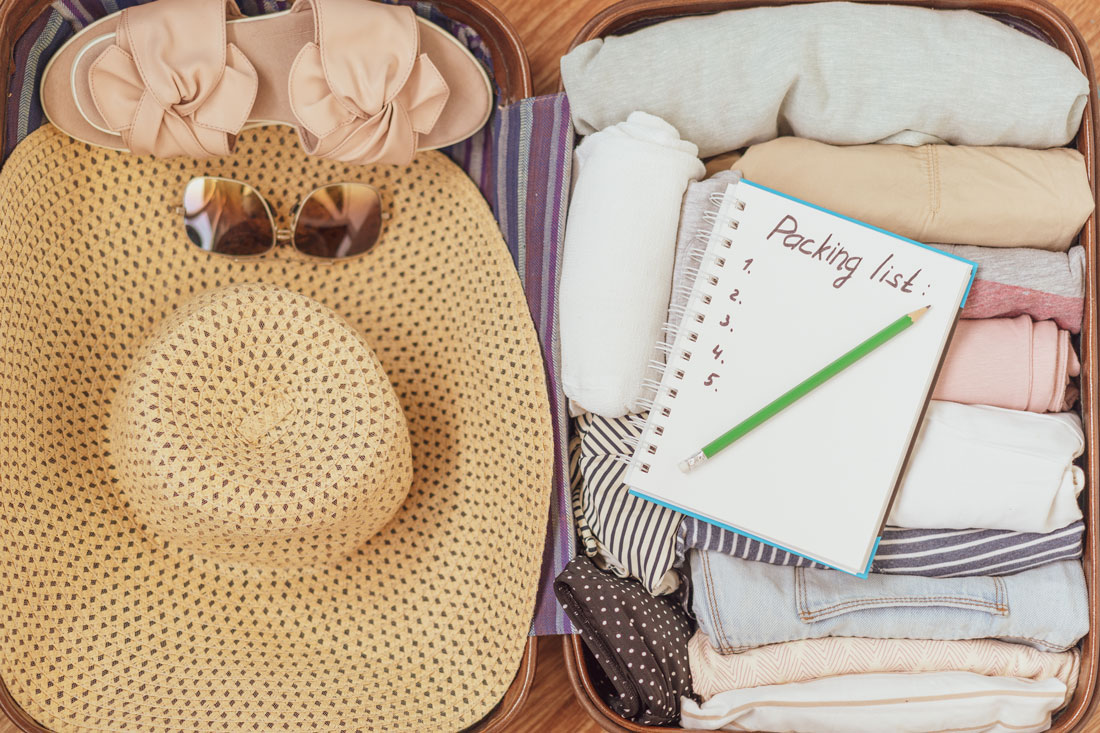 a packed suitcase and packing list to move to senior living